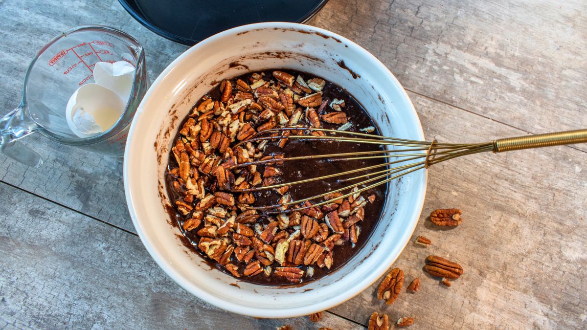 Adding pecans to the brownie batter with too much butter