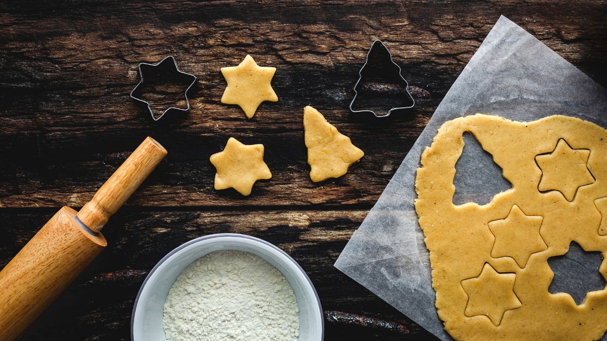 Cutting Out Gingerbread Dough Shapes on Parchment Paper