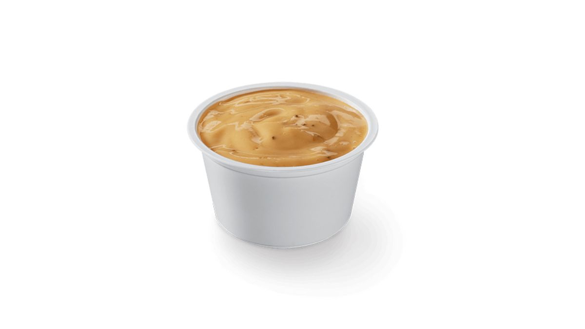 Little Caesars Caesar Dip Buffalo Ranch in a Plastic Dish on White Background