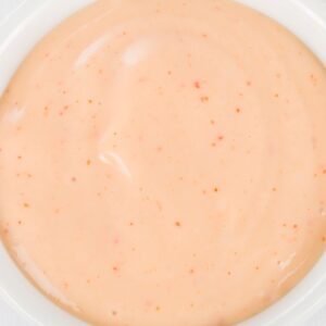 pink Panera Signature Sauce in white sauce dish on white background