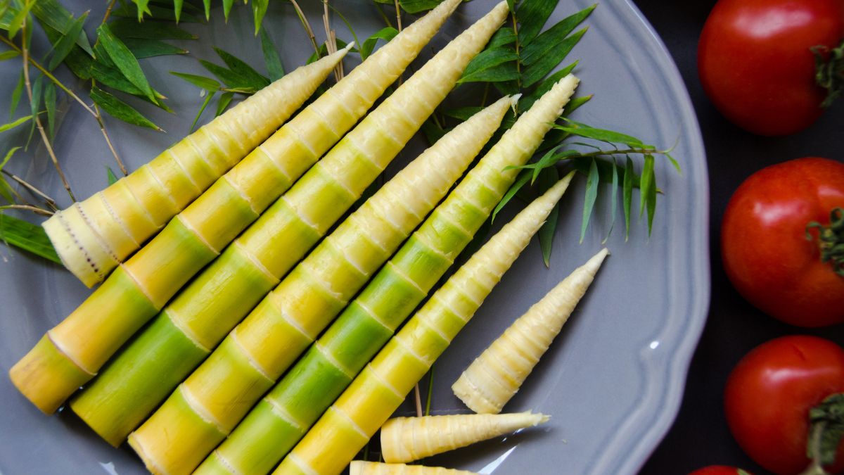 Raw Green Bamboo Shoots on a Plate Next to Tomatoes