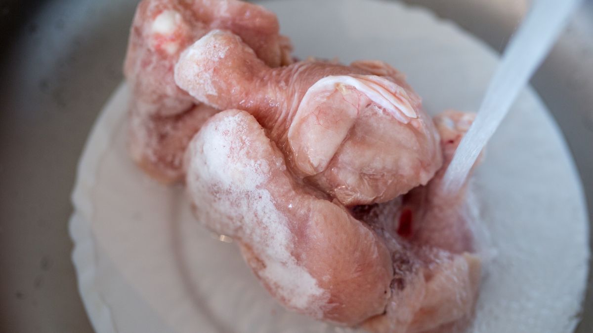 Thawing raw turkey in cold water.