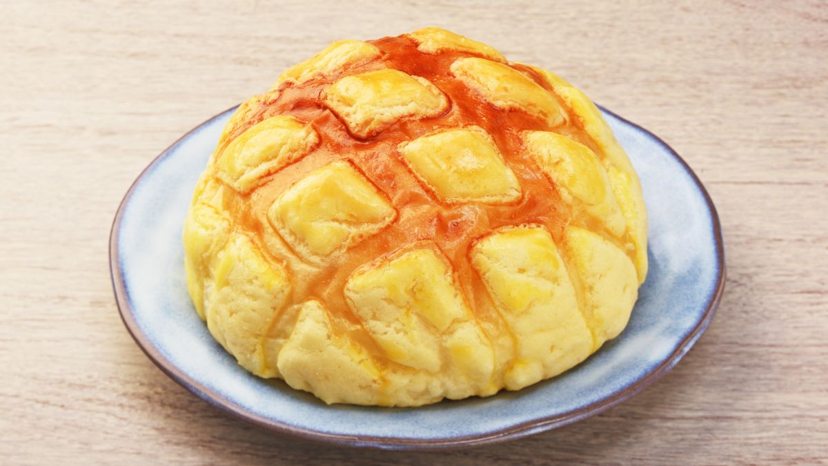 pineapple bun served ona plate on a wooden table