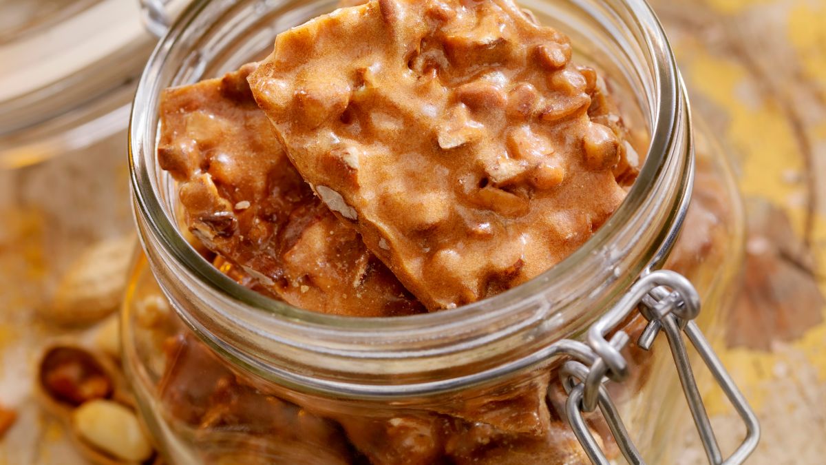 Peanut brittle in an airtight, glass container.