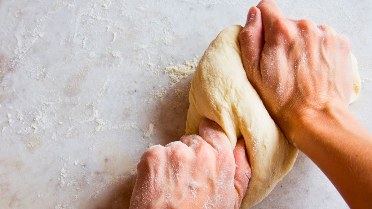 fixing bread dough with too much butter by kneading vigorously
