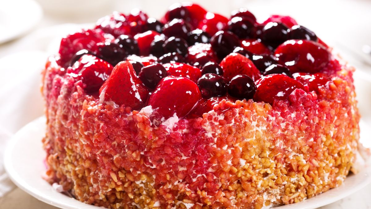 lane cake with berry fruits on white plate