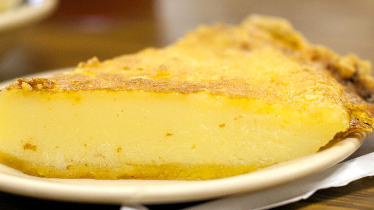 lemon chess pie served on a white plate, closeup